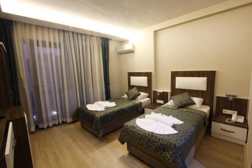 a hotel room with two beds at Inciler Hotel in Altınoluk