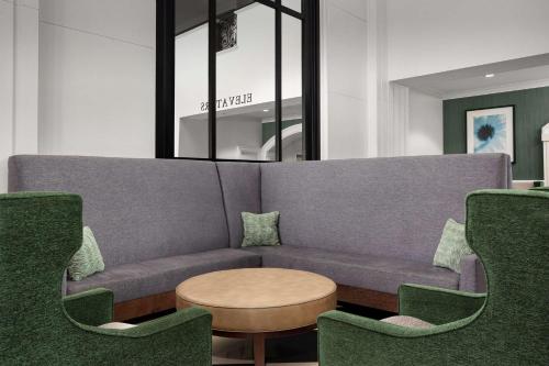 a living room with a couch and chairs at DoubleTree by Hilton Chicago O'Hare Airport-Rosemont in Rosemont