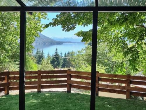 a view of a lake from a house window at Tiny House Melgarejo in San Carlos de Bariloche