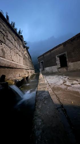 a stream of water next to a building at La Fonda de Xiva in Chiva de Morella
