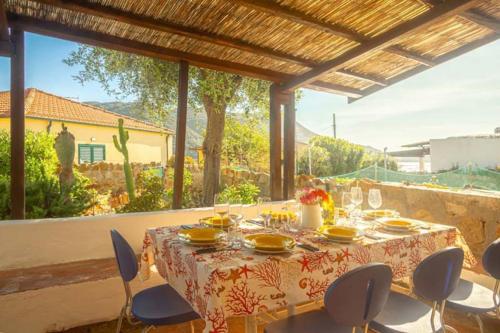 a table with chairs and a table cloth on a patio at Silva in Campese