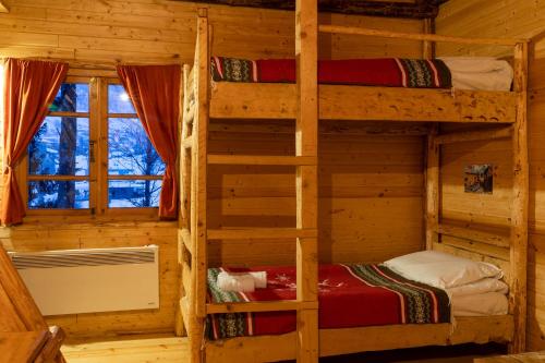 a bedroom with two bunk beds in a log cabin at Mestia Eco Huts in Mestia
