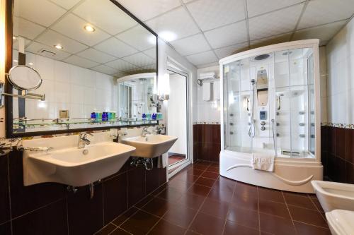 a bathroom with two sinks and a shower at Portaluna Hotel & Resort in Jounieh