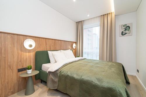 a bedroom with a large bed and a window at #stayhere - New & Stylish Minimalistic 1BDR Vilnius City Center in Vilnius