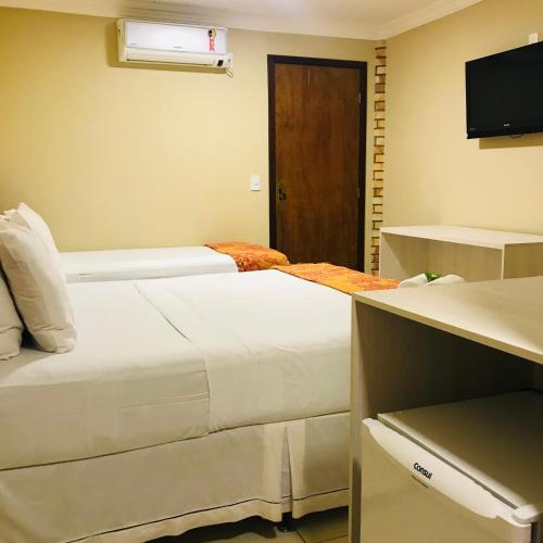 Una cama o camas en una habitación de Hotel Pousada Latitude