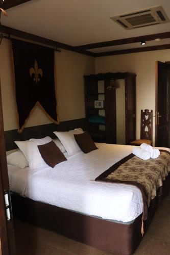 a bedroom with two large beds with white pillows at Castillo Medieval in Viña del Mar