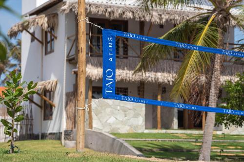 a blue street sign in front of a building at Casa Tajo - Atins in Atins