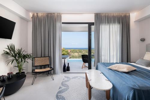 a bedroom with a blue bed and a view of the ocean at Nuovo Luxury Suites in Daratso