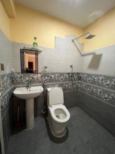 a bathroom with a toilet and a sink at Hotel Village View Nagarkot in Nagarkot