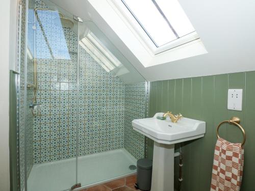 a bathroom with a sink and a shower at The Little Hay Barn in Norwich