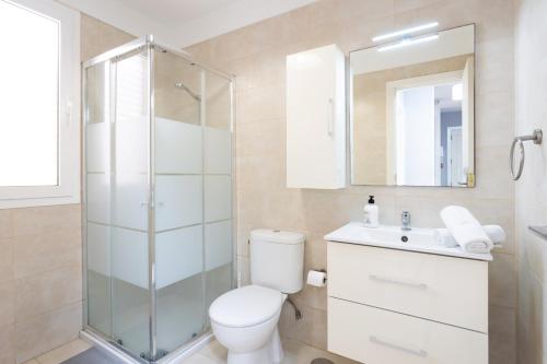 a bathroom with a shower and a toilet and a sink at Caletillas Waves & Pool in Candelaria