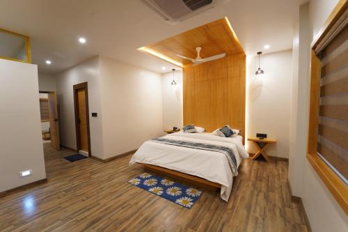 een slaapkamer met een bed en een houten muur bij Dvr Mansion in Kurnool