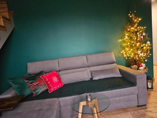 a living room with a couch and a christmas tree at Złota Widokówka in Jaworze