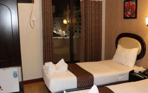Postel nebo postele na pokoji v ubytování Grand Sina Hotel