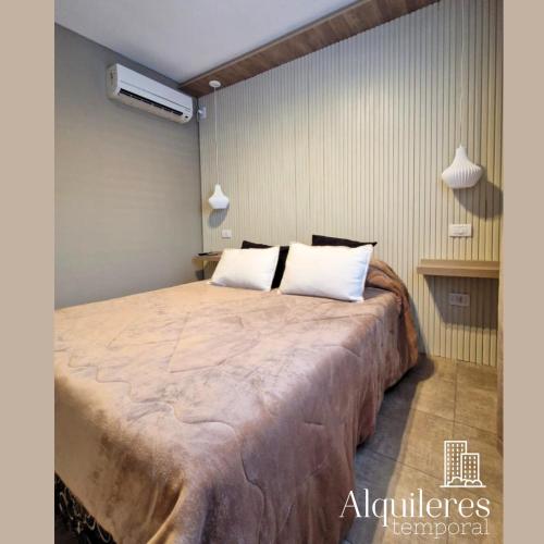 a bedroom with a large bed with white pillows at m boero 3231 in Rosario