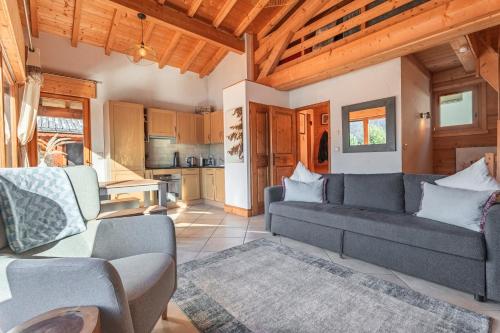 a living room with a couch and a kitchen at Beautiful 2 bed Chalet Morzine in Morzine