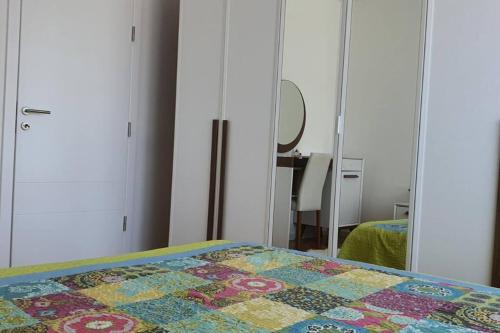 a bedroom with a bed with a quilt on it at Perfect Place for Your Vacation in Gjilan