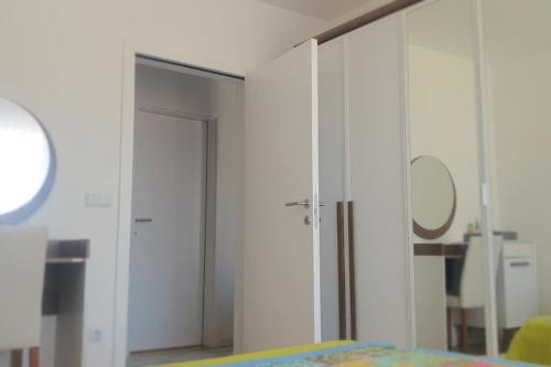 a bedroom with a door leading into a room at Perfect Place for Your Vacation in Gjilan