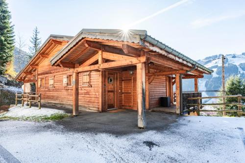a wooden cabin with a large door in the snow at 2 bed Chalet, sleeps 5 with shared pool - Morzine in Morzine