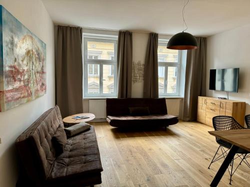 a living room with a couch and a table at Atelier Lomani in Vienna