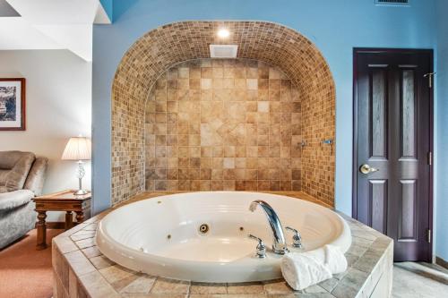 a large tub in a room with a brick wall at Chula Vista Condo 2145 & 2147 Full Property in Wisconsin Dells