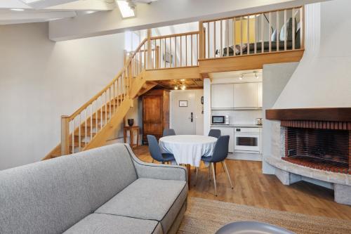 a living room with a couch and a fireplace at Hôtel de la Couronne in Morges