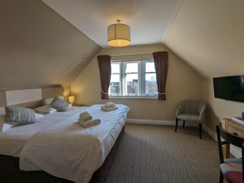 a bedroom with two beds and a window at The Seal in Selsey