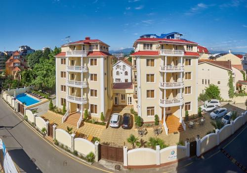 an apartment building with a pool in a city at Black Sea Guest House in Adler