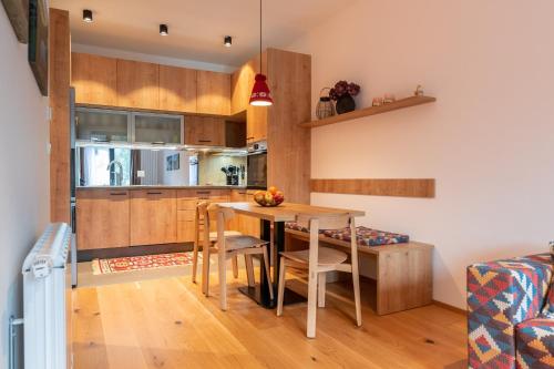 a kitchen and dining room with a table and chairs at Apartments Nomad Bjelašnica in Bjelašnica