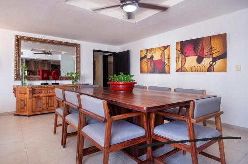 a dining room with a wooden table and chairs at Fantastic family villa on the best beach of Cancun in Cancún