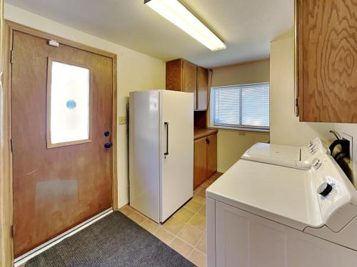 a kitchen with a white refrigerator and a window at Quiet Mountain Hideaway in Alto