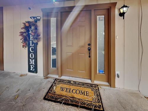 a welcome mat in front of a door with a welcome sign at Quiet Mountain Hideaway in Alto