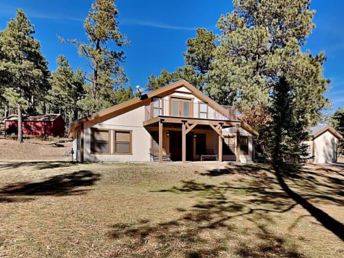 a small house on a field with trees at Quiet Mountain Hideaway in Alto