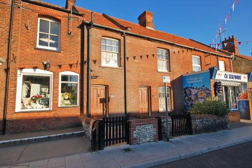 a red brick building with a sign on it at Annies, 30 Station Road in Sheringham