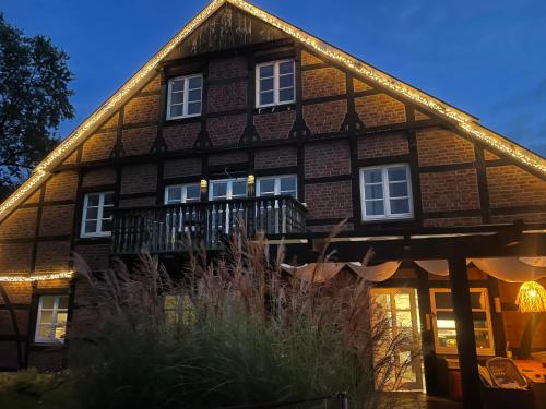 abered house with a balcony in front of it at Weberhof-Münster 2 in Münster