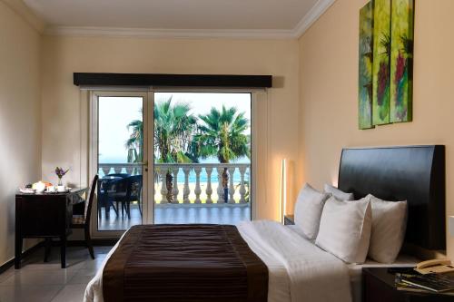 a bedroom with a bed and a view of a balcony at Portaluna Hotel & Resort in Jounieh