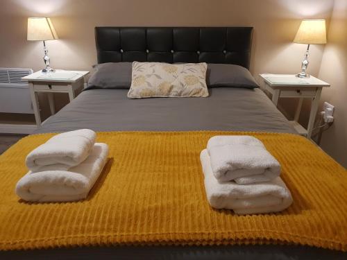 a bedroom with a bed with towels on it at The Savile - Luxury Apartment Leeds - Your Next Stay in Leeds