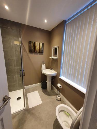 a bathroom with a shower toilet and a sink at The Savile - Luxury Apartment Leeds - Your Next Stay in Leeds