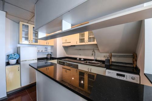 a kitchen with a sink and a counter top at Portaluna Hotel & Resort in Jounieh