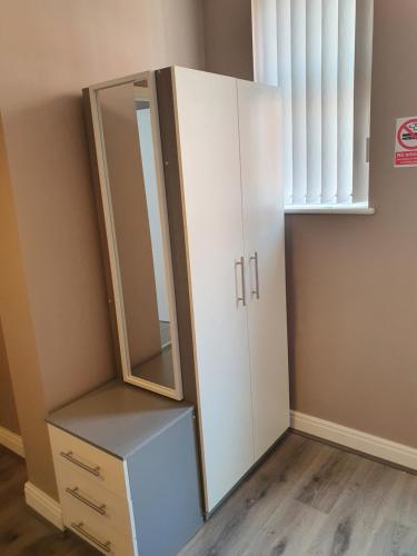 a dressing room with a mirror and a cabinet at The Savile - Luxury Apartment Leeds - Your Next Stay in Leeds
