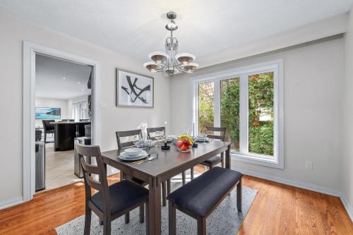a dining room with a table and chairs at Large & Sunny Private bedroom in Villa in Toronto