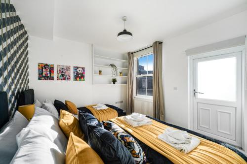 a living room with a couch and a window at Central Hackney Abode - Balcony in London