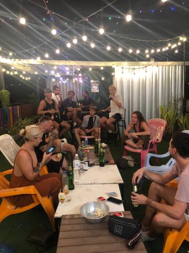 a group of people sitting around a table with drinks at Revolution Asoke in Bangkok