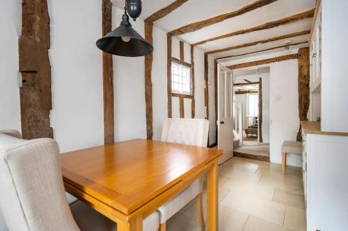 a dining room with a wooden table and chairs at Dragonfly Cottage, Long Melford in Long Melford