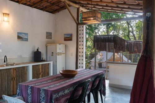 a kitchen with a table with a bowl on it at Glamping Coco Dendê - Algodões in Praia dos Algodões