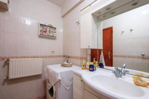a bathroom with a sink and a mirror at Villa with Garden 10 min to Sapanca Lake in Izmit