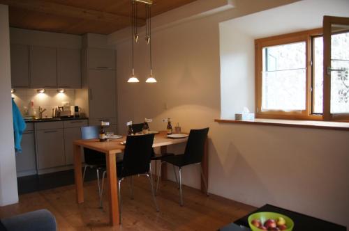 a kitchen with a table and chairs in a room at Chasa Pro La Tuor Pitschna in Ardez