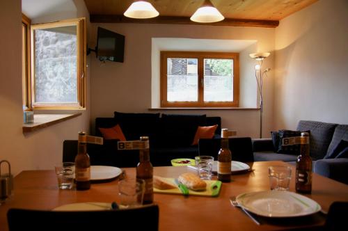a dining room table with a couch and a table and chairs at Chasa Pro La Tuor Pitschna in Ardez
