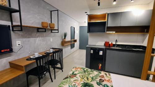 a kitchen and a dining room with a table in a room at Flats Tramonto - By EasyHost in João Pessoa