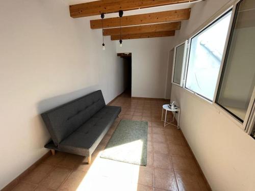 a living room with a couch and a window at Large Apartment in el Raval in Barcelona